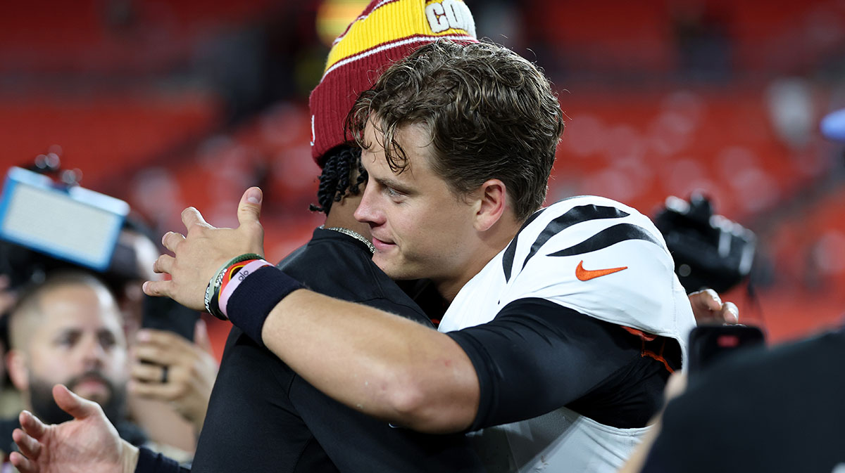 Cincinnati Bengals quarterback Joe Burrow (9) greets Washington Commanders quarterback Jayden Daniels (5) after their game at Northwest Stadium.
