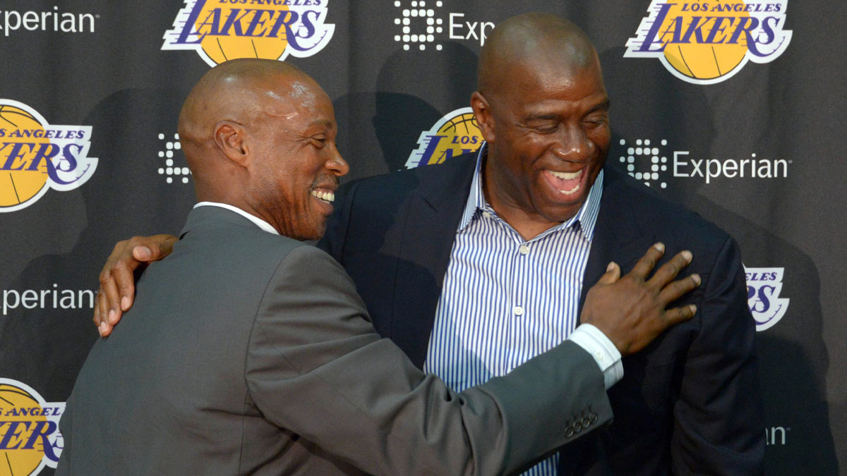 Byron Scott (left) is embraced by Magic Johnson at a press conference to introduce Scott as Los Angeles Lakers coach at Toyota Sports Center.