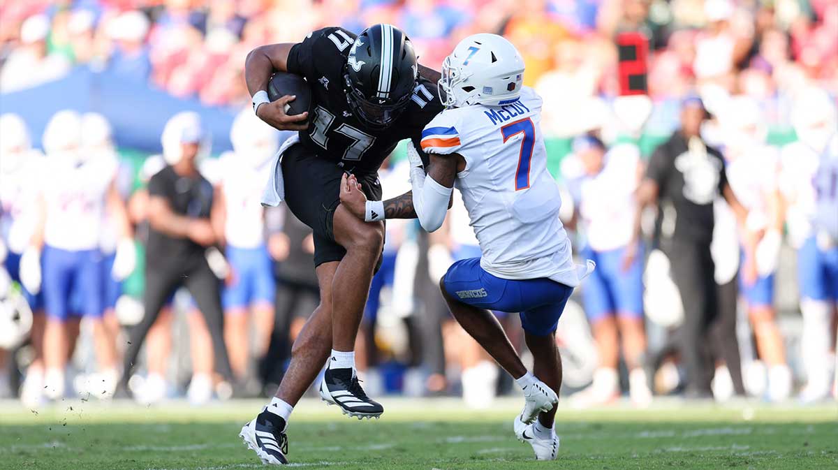 South Florida Bulls quarterback Byrum Brown (17) runs with the ball chased by Boise State Broncos defensive back A'Marion McCoy (7) in the second quarter against the Boise State Broncos in the second quarter at Raymond James Stadium.