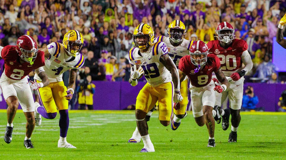 LSU Tigers running back Caden Durham (29) breaks free in the open field against Alabama Crimson Tide defensive back DeVonta Smith (8) at Tiger Stadium.
