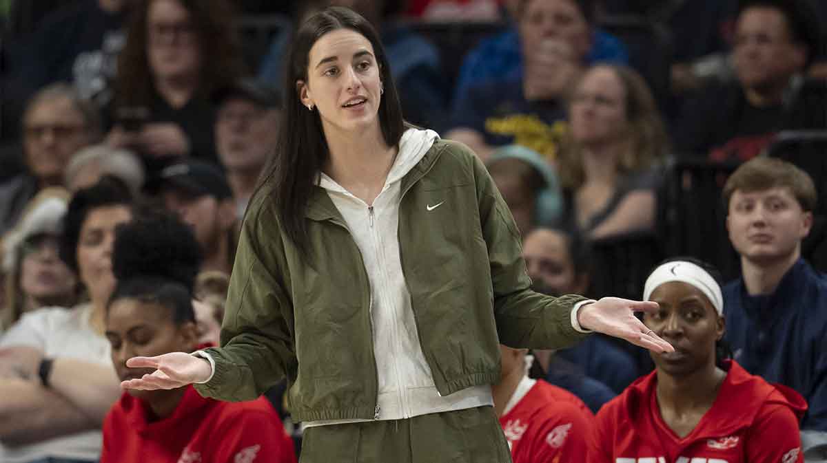 Indiana Fever guard Caitlin Clark (22) looks on from the bench against the Minnesota Lynx in the second half at Target Center.
