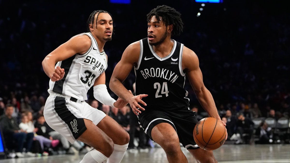 Feb 10, 2024; Brooklyn, New York, USA; Brooklyn Nets shooting guard Cam Thomas (24) dribbles the ball against San Antonio Spurs point guard Tre Jones (33) during the second half at Barclays Center. Mandatory Credit: Gregory Fisher-Imagn Images