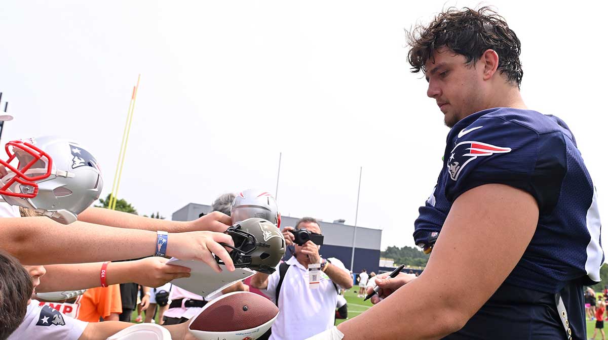 New England Patriots offensive tackle Will Campbell (66) signs autographs after training camp at Gillette Stadium.