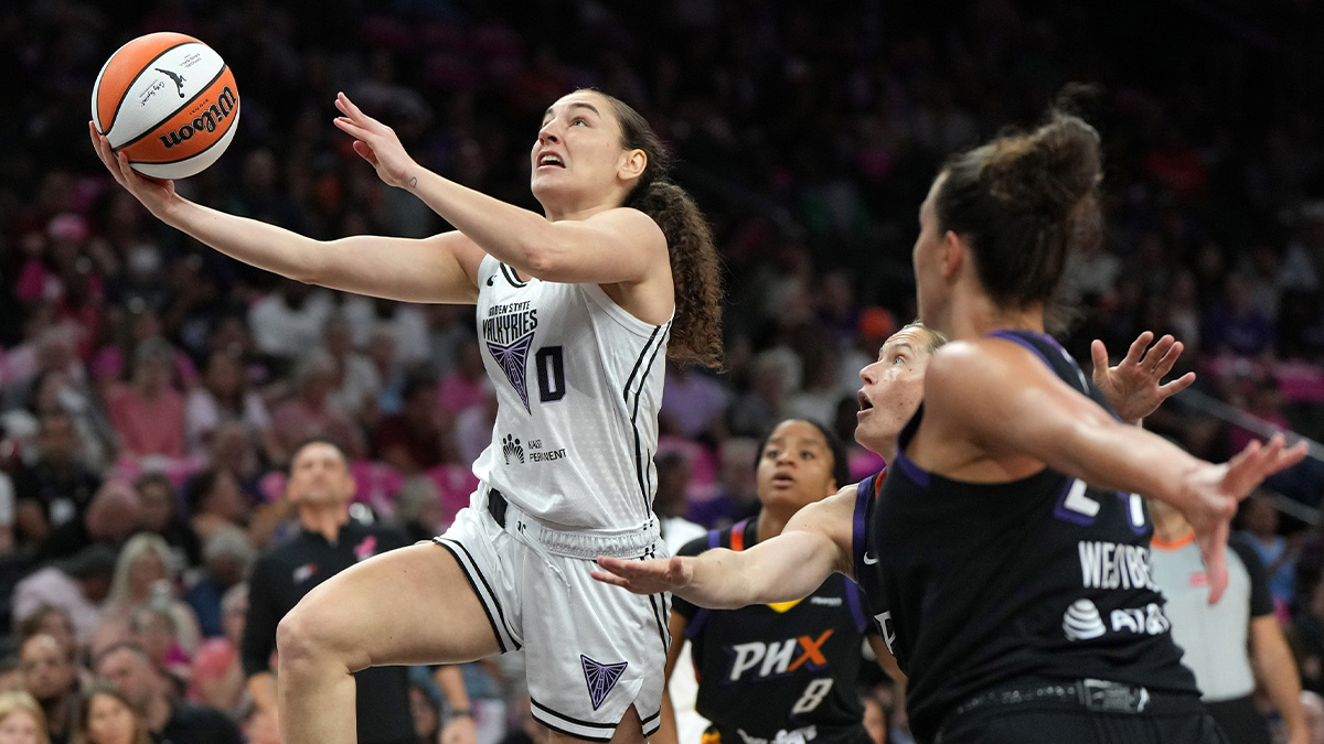 Golden State Valkyries guard Carla Leite (0) drives past Phoenix Mercury guard Monique Akoa Makani (8), guard Sami Whitcomb (33), and forward Kathryn Westbeld (24) in the first half at Footprint Center.