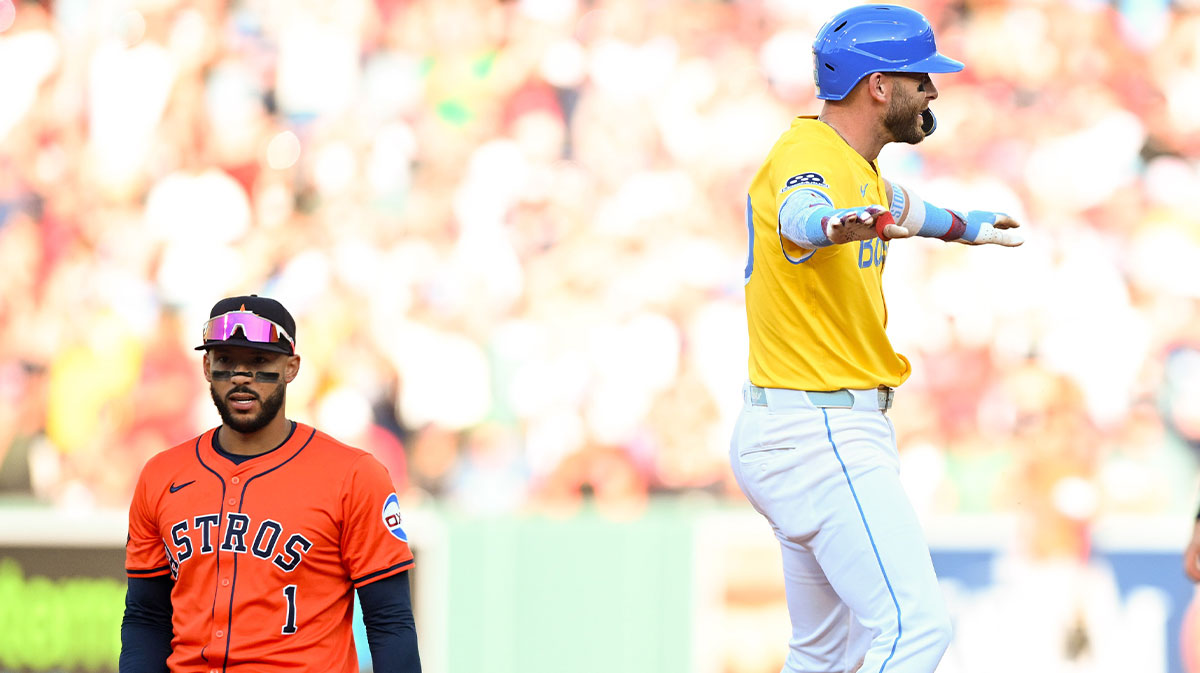 Boston Red Sox shortstop Trevor Story (10) reacts after hitting a RBI double in front of Houston Astros shortstop Carlos Correa (1) during the seventh inning at Fenway Park.