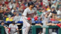 Boston Red Sox catcher Carlos Narvaez (75) watches the ball after hitting a two-run home run against the Philadelphia Phillies in the eleventh inning at Citizens Bank Park.
