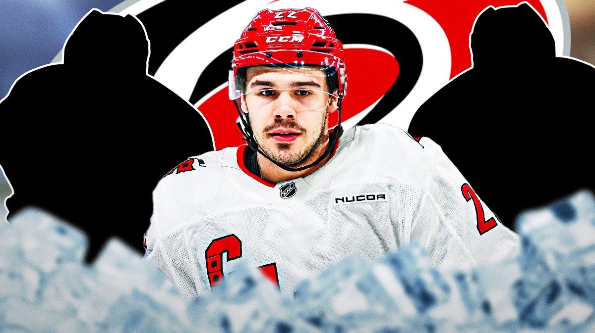Logan Stankoven in the middle with two mystery players. Hurricanes logo in the background.