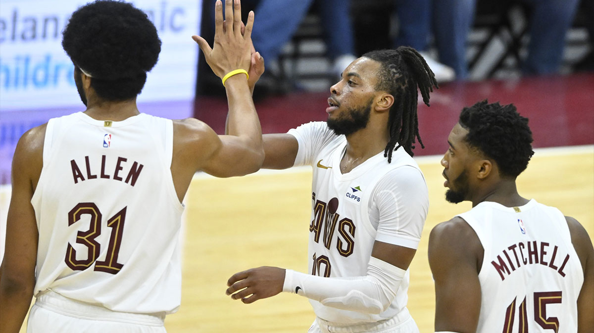 Cavaliers center Jarrett Allen (31), guard Darius Garland (10), and guard Donovan Mitchell (45) celebrate in the fourth quarter against the Toronto Raptors at Rocket Mortgage FieldHouse
