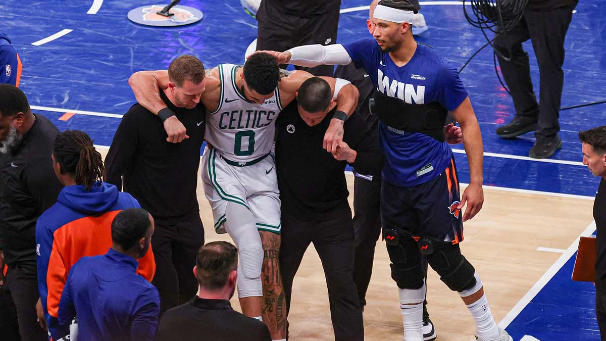 Celtics forward Jayson Tatum (0) is helped off the court by after an injury in the second half during game four of the second round for the 2025 NBA Playoffs against the New York Knicks at Madison Square Garden. Tatum would leave the game with an injury after this play