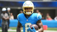 Los Angeles Chargers running back Omarion Hampton (8) carries the ball before the game against the New Orleans Saints at SoFi Stadium.