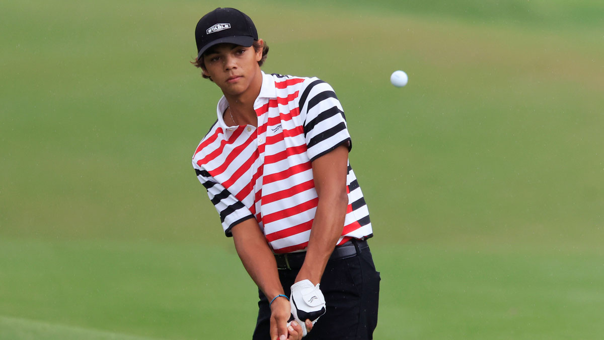Charlie Woods of Jupiter, Fla. chips on on the 13th hole during the third and final round of The Junior Players Championship golf tournament at TPC Sawgrass