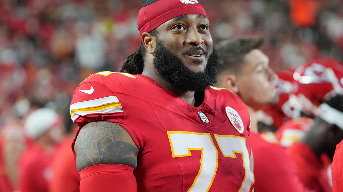 Kansas City Chiefs offensive tackle Lucas Niang (77) on the sidelines against the Chicago Bears during the game at GEHA Field at Arrowhead Stadium.