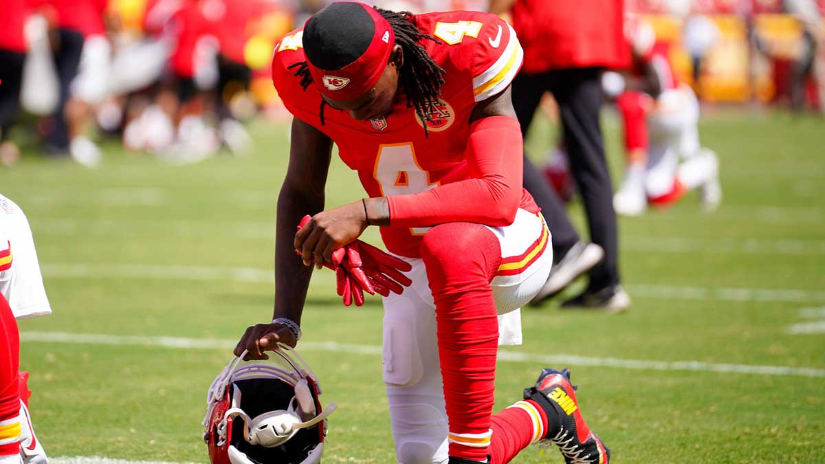 Kansas City Chiefs wide receiver Rashee Rice (4) kneels on field against the Detroit Lions prior to the game at GEHA Field at Arrowhead Stadium.