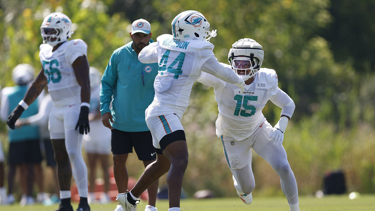 Miami Dolphins linebacker Chop Robinson (44) and linebacker Jaelan Phillips (15) run on the field before joint training camp practice with the Chicago Bears ahead of Sunday's preseason opener.