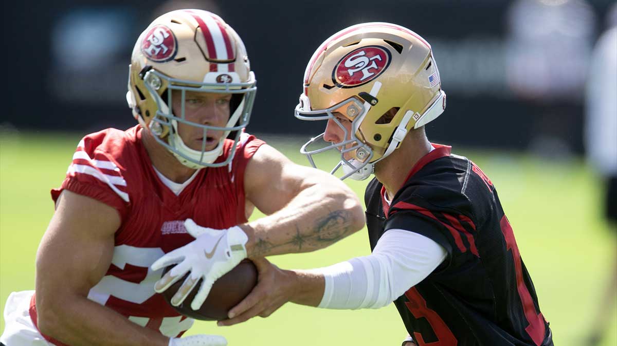 San Francisco 49ers quarterback Brock Purdy (13) hands off to running back Christian McCaffrey (23) during the first day of training camp at SAP Performance Facility.