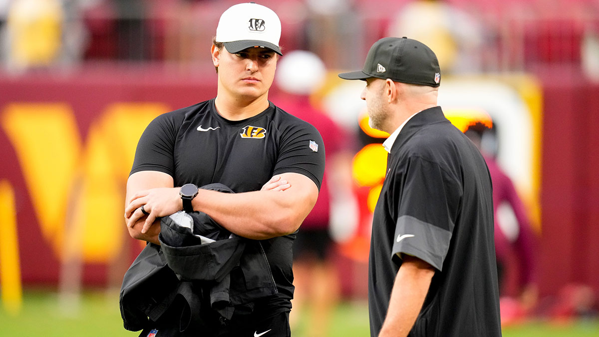 Cincinnati Bengals defensive end Trey Hendrickson (91) talks with director of player personnel Duke Tobin before the first quarter of the NFL Preseason Week 2 game between the Washington Commanders and the Cincinnati Bengals at Northwest Stadium in Landover, Md., on Monday, Aug. 18, 2025.