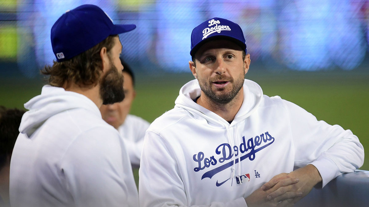 Los Angeles Dodgers starting pitcher Max Scherzer (31) speaks with starting pitcher Clayton Kershaw (22) during the third inning at Dodger Stadium.