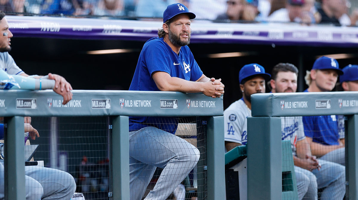 Los Angeles Dodgers pitcher Clayton Kershaw (22) looks on from the dugout in the first inning against the Colorado Rockies at Coors Field.