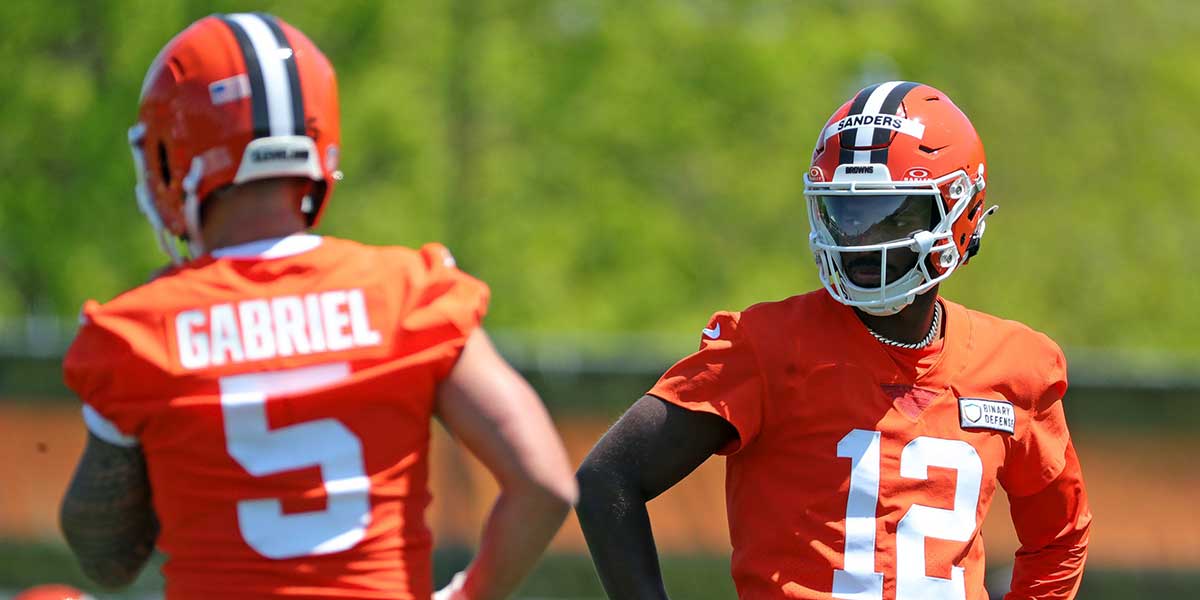 Cleveland Browns quarterback Shedeur Sanders (12) watches quarterback Dillon Gabriel (5) during day two of NFL rookie minicamp at the Cleveland Browns training facility on Saturday, May 10, 2025, in Berea, Ohio.