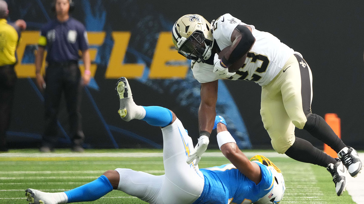New Orleans Saints running back Clyde Edwards-Helaire (23) carries the ball against Los Angeles Chargers cornerback Jordan Oladokun (37) in the second half at SoFi Stadium.