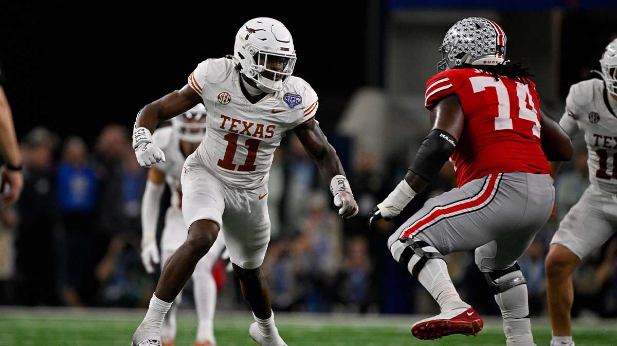 Texas Longhorns linebacker Colin Simmons (11) and Ohio State Buckeyes offensive lineman Donovan Jackson (74) in action during the game between the Texas Longhorns and the Ohio State Buckeyes at AT&T Stadium.