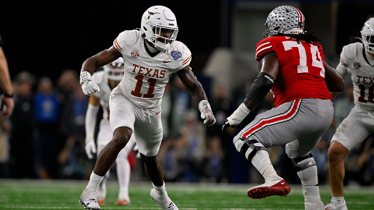 Texas Longhorns linebacker Colin Simmons (11) and Ohio State Buckeyes offensive lineman Donovan Jackson (74) in action during the game between the Texas Longhorns and the Ohio State Buckeyes at AT&T Stadium.