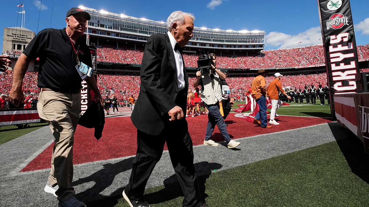 Lee Corso walks across the field prior to the NCAA football game between the Ohio State Buckeyes and the Texas Longhorns at Ohio Stadium on Aug. 30, 2025.