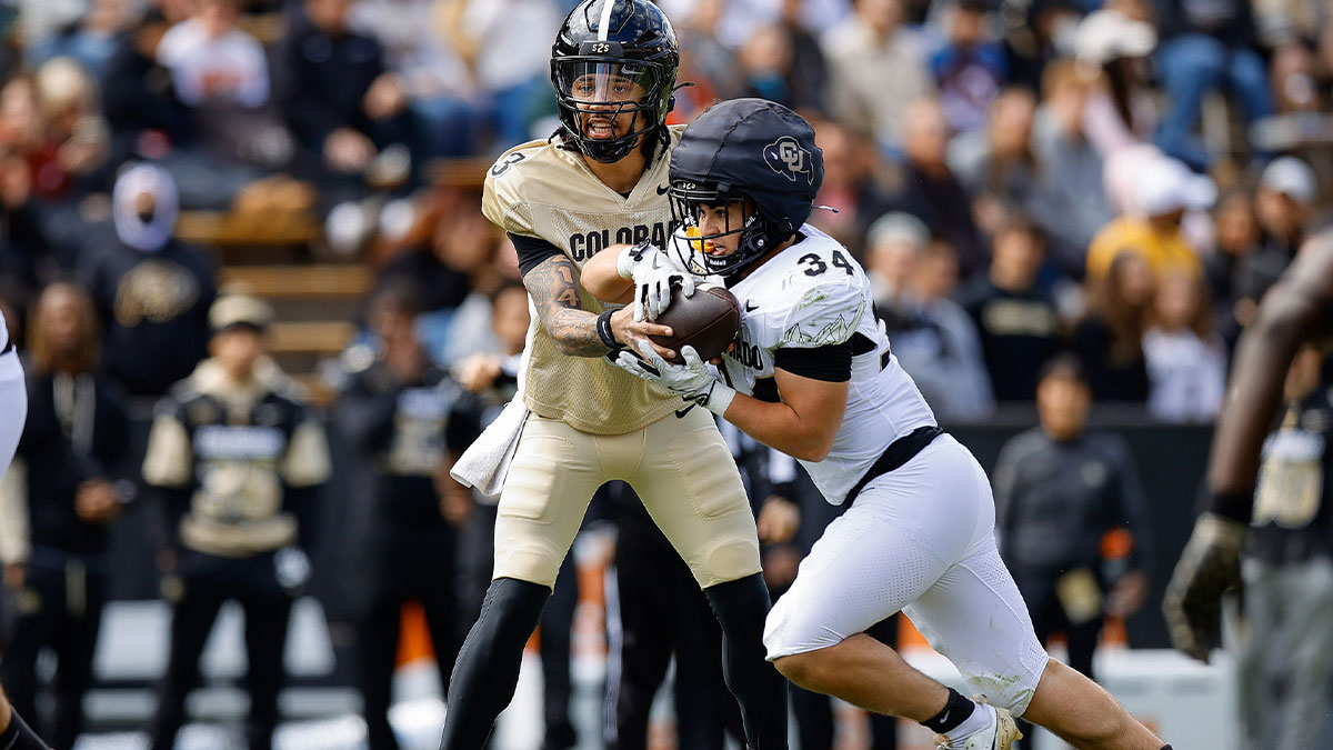 Colorado Buffaloes quarterback Kaidon Salter (3) hands the ball off to running back Titus Bautista (34) during the spring game at Folsom Field.