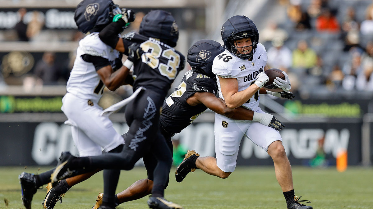 Colorado Buffaloes running back Christian Sarem (48) is tackled by inside linebacker Jeremiah Brown (42) as wide receiver Quentin Gibson (15) defends against cornerback Kole Mathis (33) during the spring game at Folsom Field.