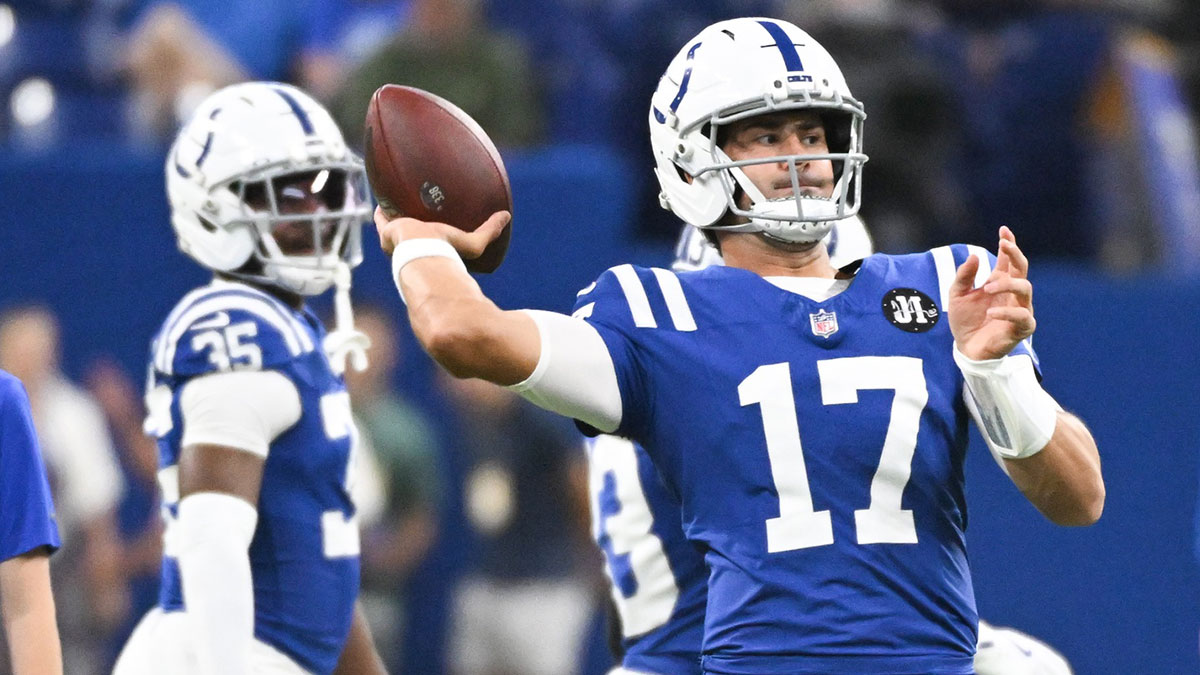 Colts quarterback Daniel Jones (17) throws a pass during warmups prior to the game against the Green Bay Packers at Lucas Oil Stadium with Colts QB coach Cam Turner in the background
