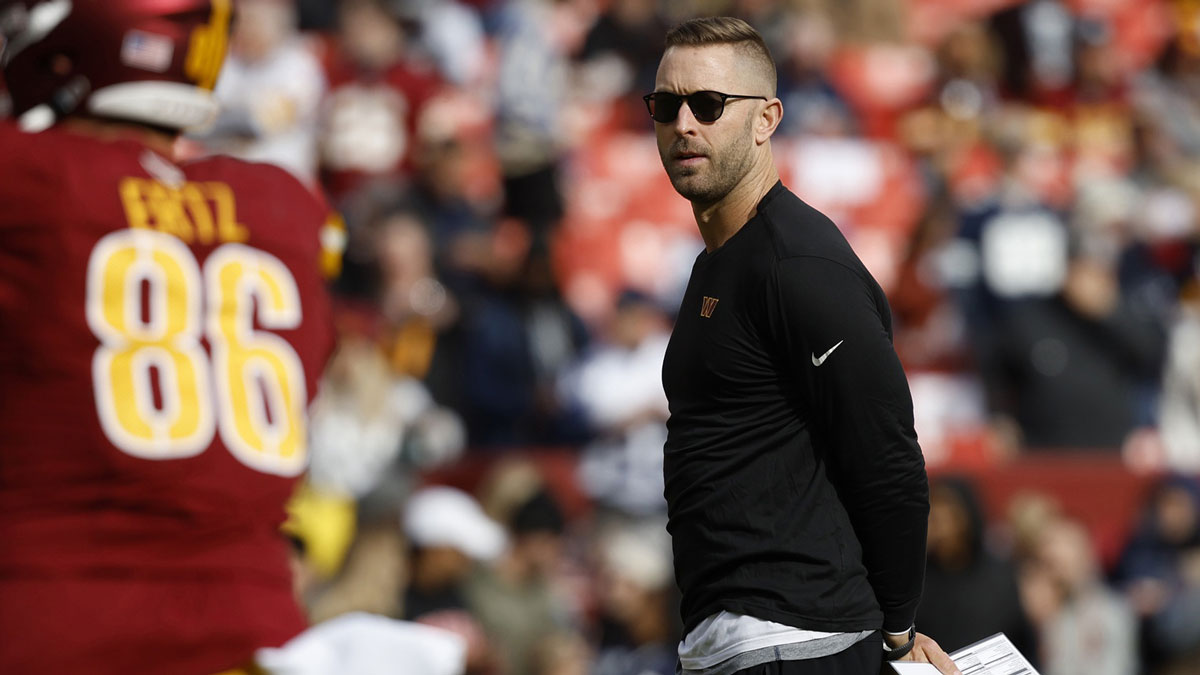 Commanders offensive coordinator Kliff Kingsbury stands on the field during warmup prior to the game against the Dallas Cowboys at Northwest Stadium