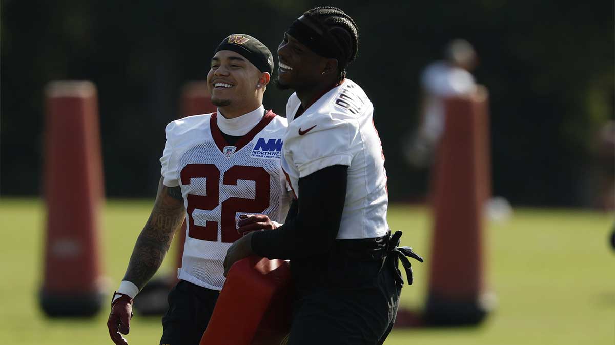Commanders running back Brian Robinson Jr. (8) jokes with Commanders cornerback Car'lin Vigers (22) during practice on day two of training camp at OrthoVirginia Training Center at Commanders Park