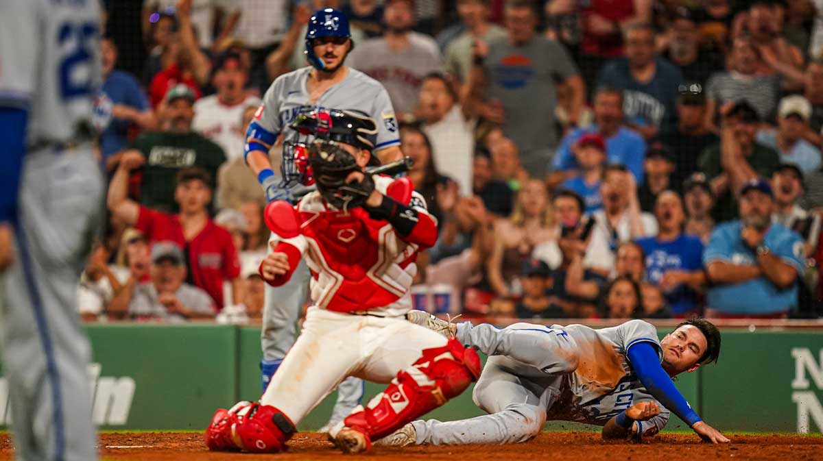 Kansas City Royals outfielder Nick Loftin (12) tagged out at home plate by Boston Red Sox catcher Connor Wong (12) to end the eighth inning at Fenway Park.
