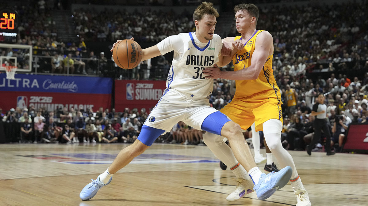 Dallas Mavericks forward Cooper Flagg (32) dribbles against Los Angeles Lakers guard Dalton Knecht (4) in the first quarter of their game at Thomas & Mack Center.