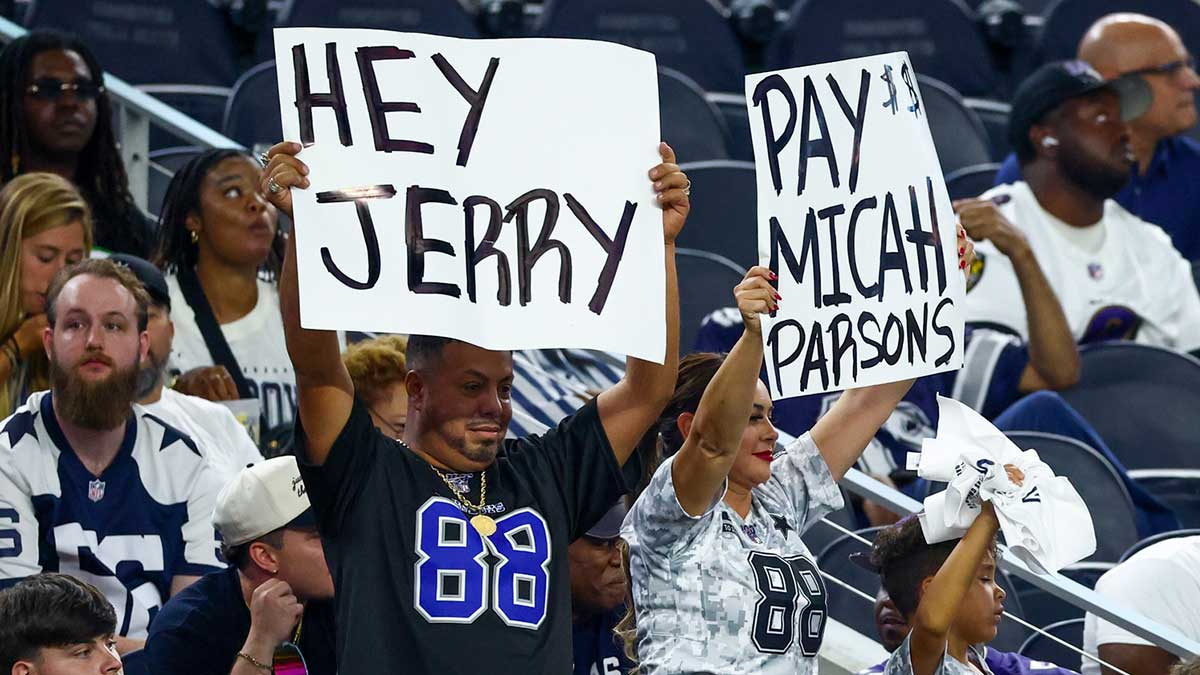 Dallas Cowboys fans hold up signs for Dallas Cowboys defensive end Micah Parsons (not pictured) during the second half against the Baltimore Ravens at AT&T Stadium.