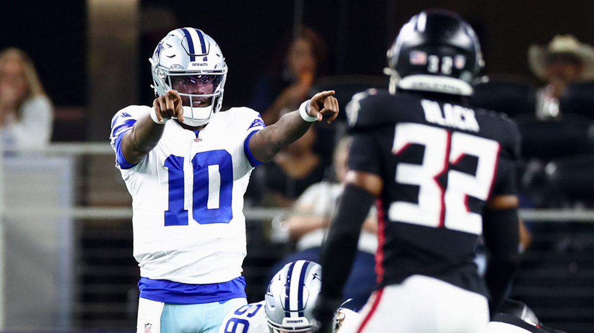 Dallas Cowboys quarterback Joe Milton III (10) points at Atlanta Falcons safety Henry Black (32) during the first half at AT&T Stadium.
