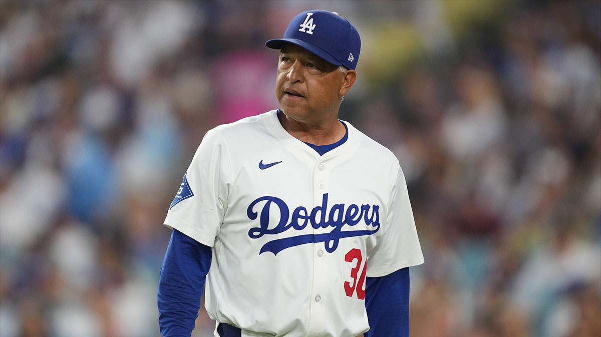 Los Angeles Dodgers manager Dave Roberts (30) walks back to the dugout in the sixth inning against the Cincinnati Reds at Dodger Stadium.