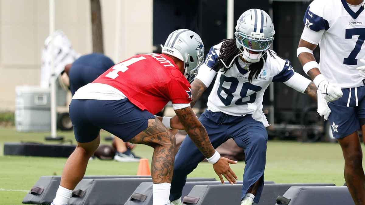 Dallas Cowboys quarterback Dak Prescott (4) celebrates with Dallas Cowboys wide receiver CeeDee Lamb (88) during a drill at the Ford Center at the Star Training Facility in Frisco, Texas.