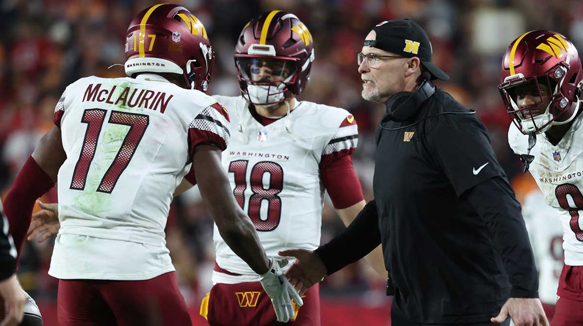 Washington Commanders wide receiver Terry McLaurin (17) celebrates with head coach Dan Quinn after catching a touchdown during the fourth quarter of a NFC wild card playoff against the Tampa Bay Buccaneers at Raymond James Stadium.