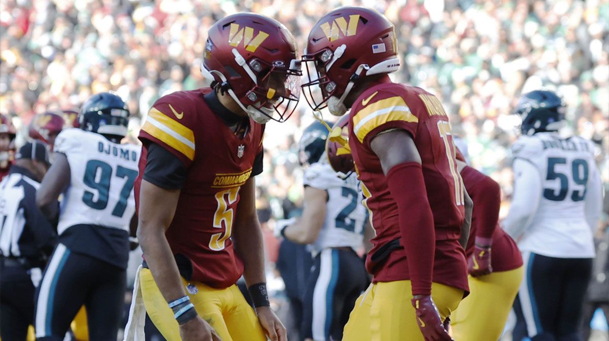 Washington Commanders quarterback Jayden Daniels (5) celebrates with Commanders wide receiver Terry McLaurin (17) after connecting on a touchdown pass against the Philadelphia Eagles during the second quarter at Northwest Stadium.
