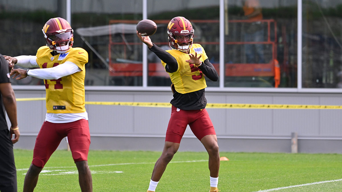 Washington Commanders quarterback Jayden Daniels (5) and quarterback Josh Johnson (14) throw passes at training camp at Gillette Stadium.