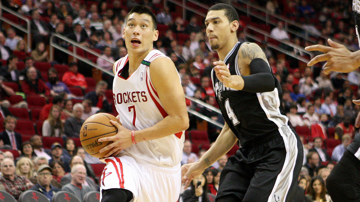 Houston Rockets point guard Jeremy Lin (7) drives the ball to the basket during the second quarter as San Antonio Spurs shooting guard Danny Green (4) defends at Toyota Center.