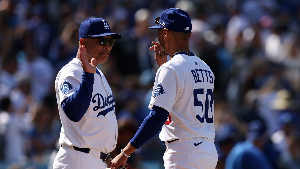 Los Angeles Dodgers manager Dave Roberts (30) and shortstop Mookie Betts (50) celebrate after defeating the New York Mets at Dodger Stadium.