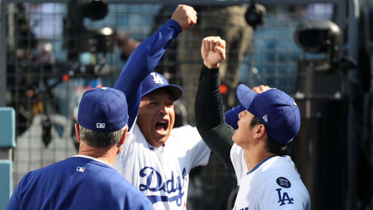 Los Angeles Dodgers manager Dave Roberts (30) and designated hitter player Shohei Ohtani (17) greet eachother before the game against the Chicago Cubs at Dodger Stadium.