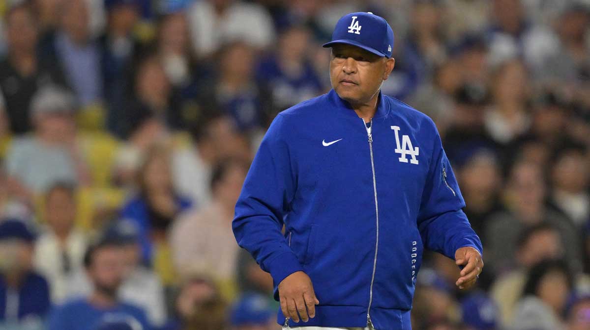 Los Angeles Dodgers manager Dave Roberts (30) walks on the field for a pitching change against the Minnesota Twins at Dodger Stadium.