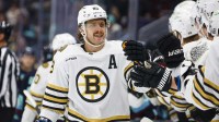 Boston Bruins right wing David Pastrnak (88) celebrates with teammates on the bench after scoring a goal against the Seattle Kraken during the first period at Climate Pledge Arena.