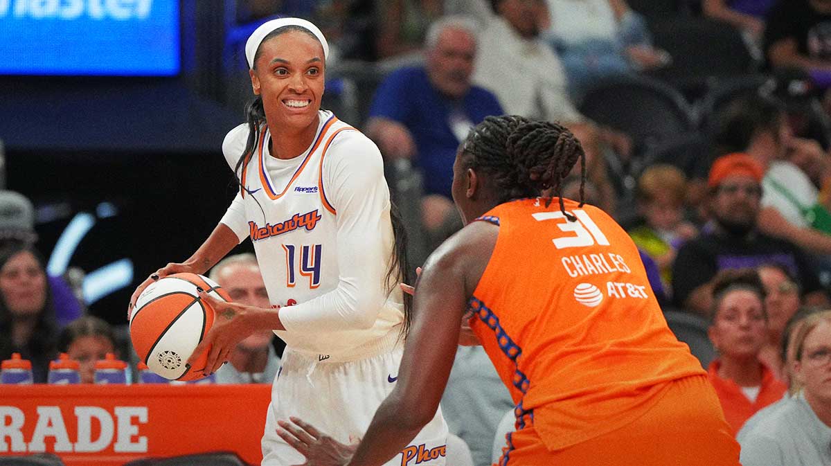 Phoenix Mercury forward DeWanna Bonner (14) shields the ball from Connecticut Sun center Tina Charles (31) in the first half at Footprint Center.
