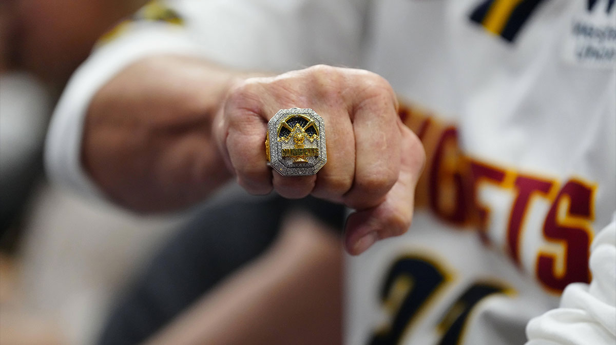 Denver Nuggets fan Gregg Sumey shows off his championship ring during the second half against the Orlando Magic at Ball Arena.