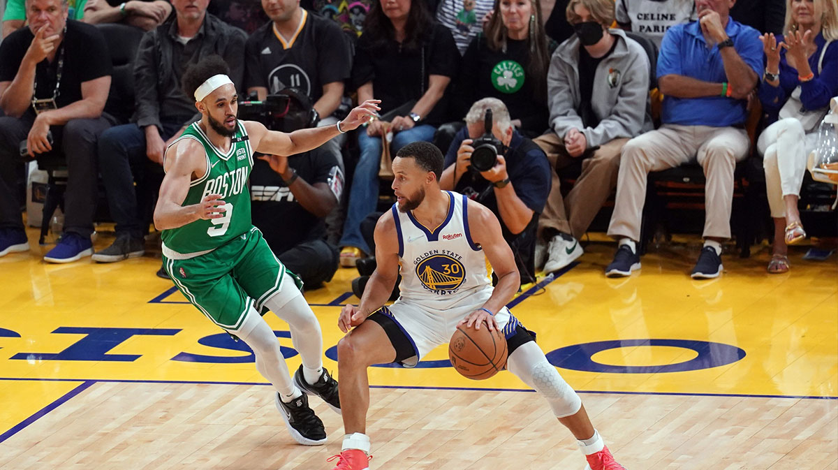 Golden State Warriors guard Stephen Curry (30) controls the ball agaisnt Boston Celtics guard Derrick White (9) in the third quarter during game two of the 2022 NBA Finals at Chase Center