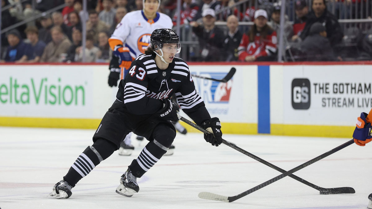 New Jersey Devils defenseman Luke Hughes (43) skates with the puck against the New York Islanders during the second period at Prudential Center.